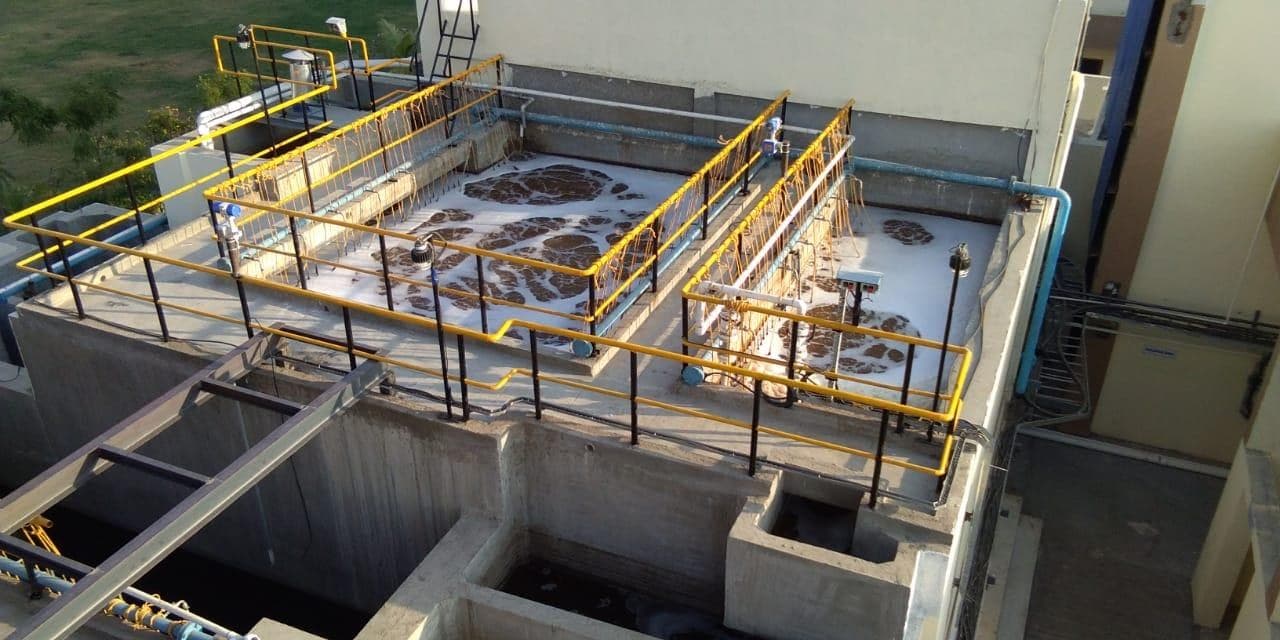 Sewage treatment plant with aeration tanks and safety railings